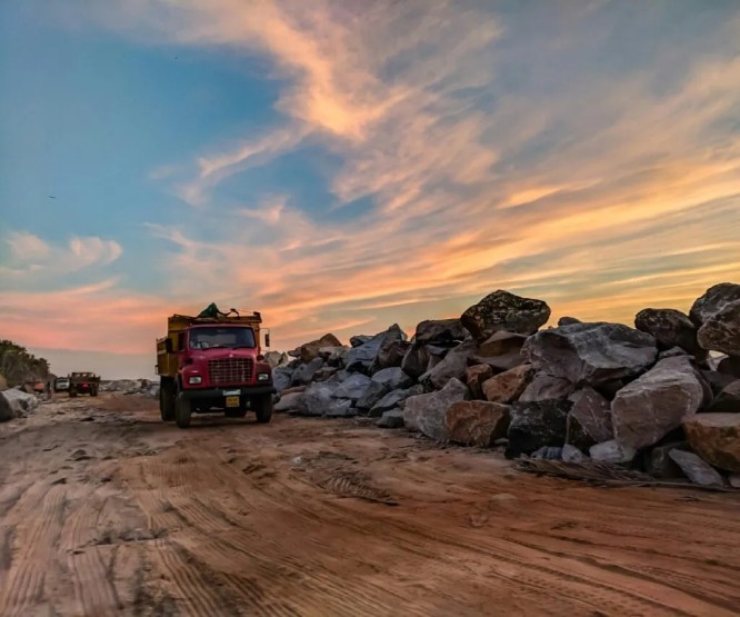 A commercial truck on a worksite at sunset
