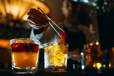 Bartender garnishing cocktails